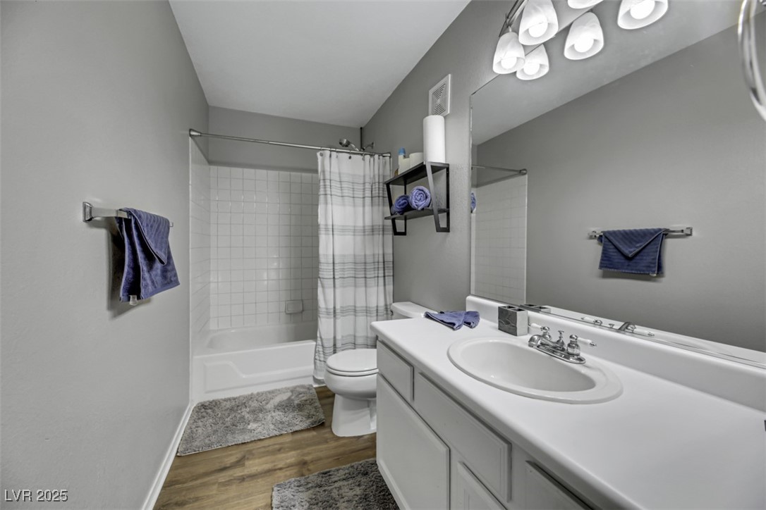 2907 Rio Sonora Court Henderson, NV 89074 - Photo 29 of 35 Bathroom with shower / bath combination with curtain, dark wood finished floors, and vanity
