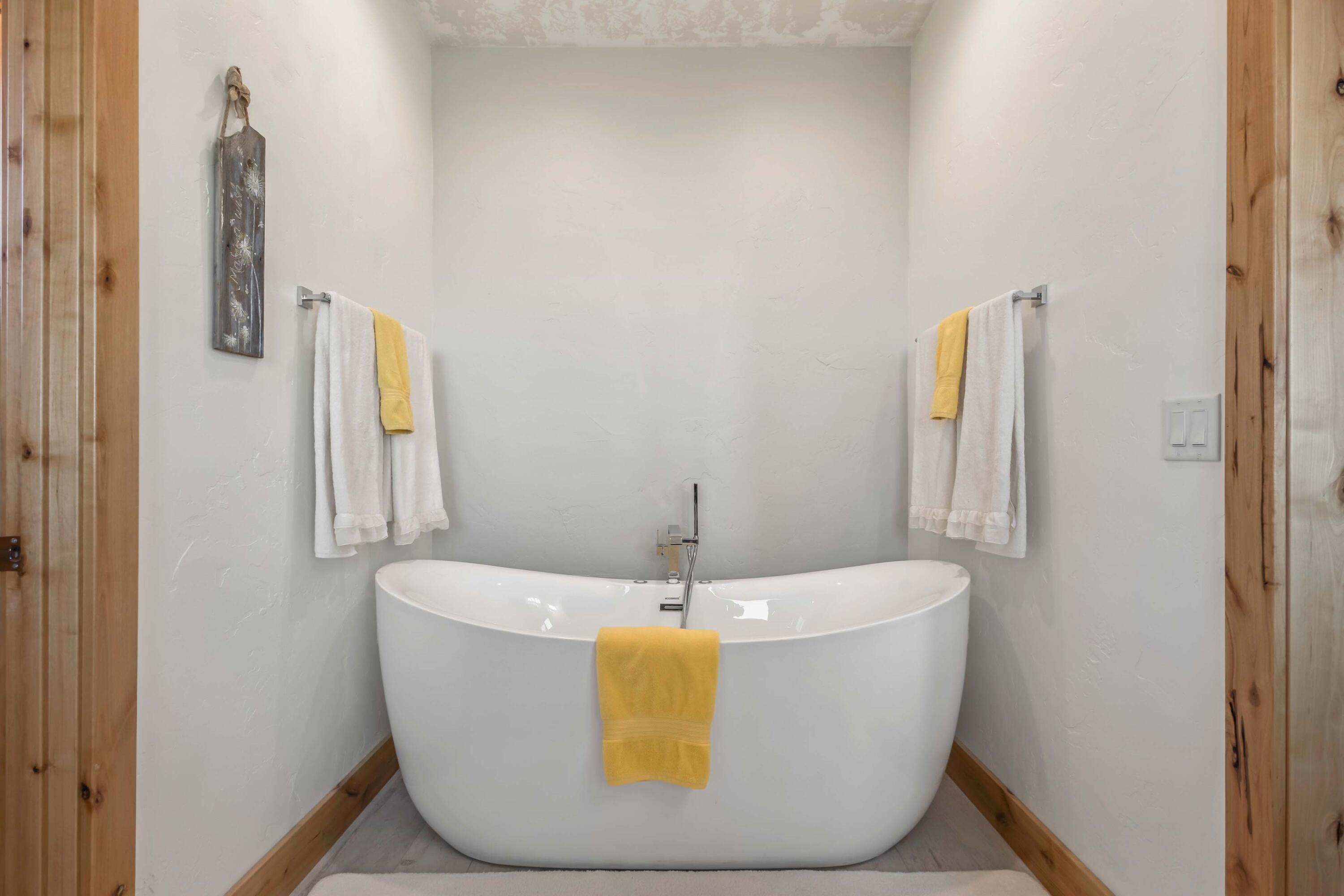 5582 North Mckay Road Prineville, OR 97754 - Photo 20 of 54 a white bath tub sitting in a bathroom