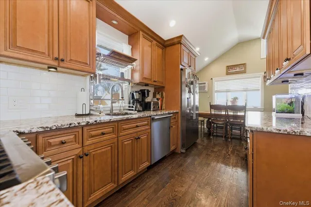 a kitchen with stainless steel appliances granite countertop sink stove and cabinets
