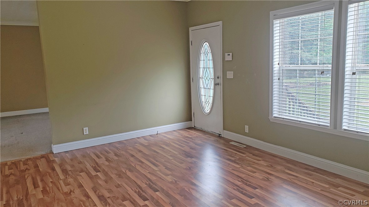 169 Old Sheppards Road Farmville, VA 23901 - Photo 2 of 17 an empty room with wooden floor and windows