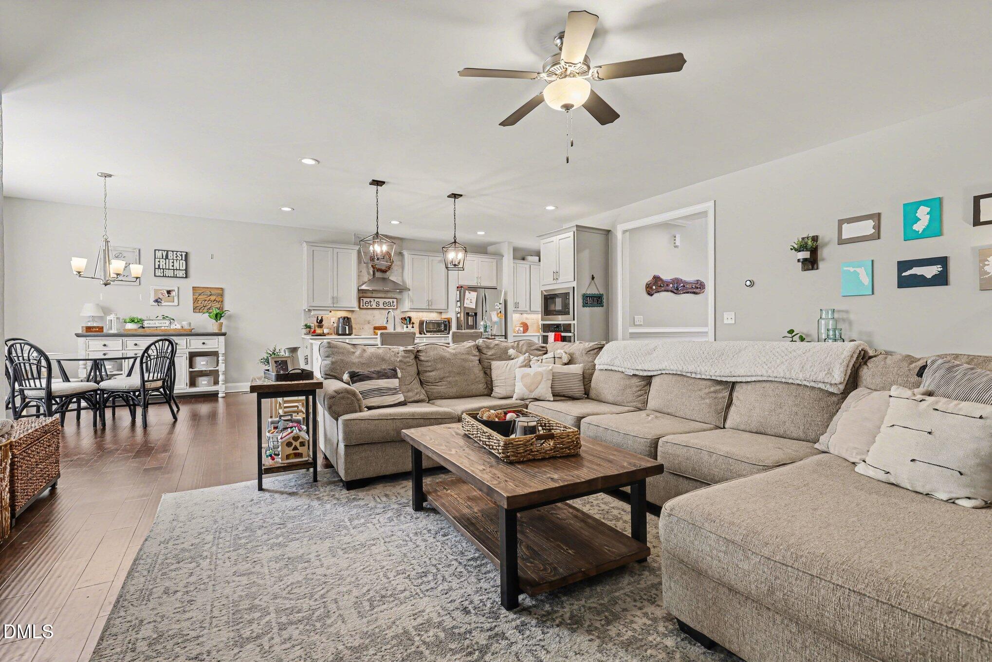 274 Colson Ridge Drive Clayton, NC 27520 - Photo 13 of 48 a living room with furniture kitchen view and a chandelier