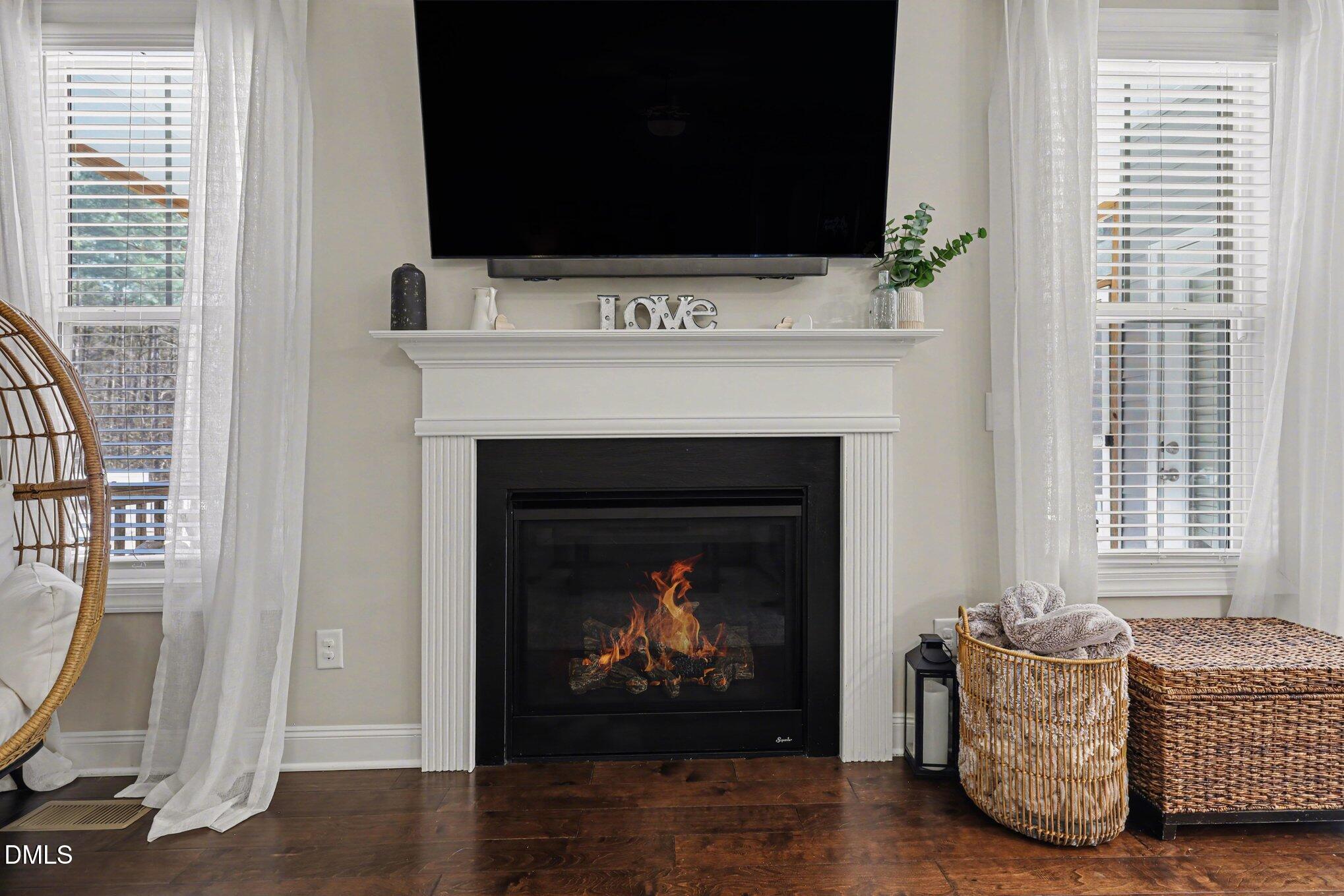 274 Colson Ridge Drive Clayton, NC 27520 - Photo 15 of 48 a living room with furniture a flat screen tv and a fireplace
