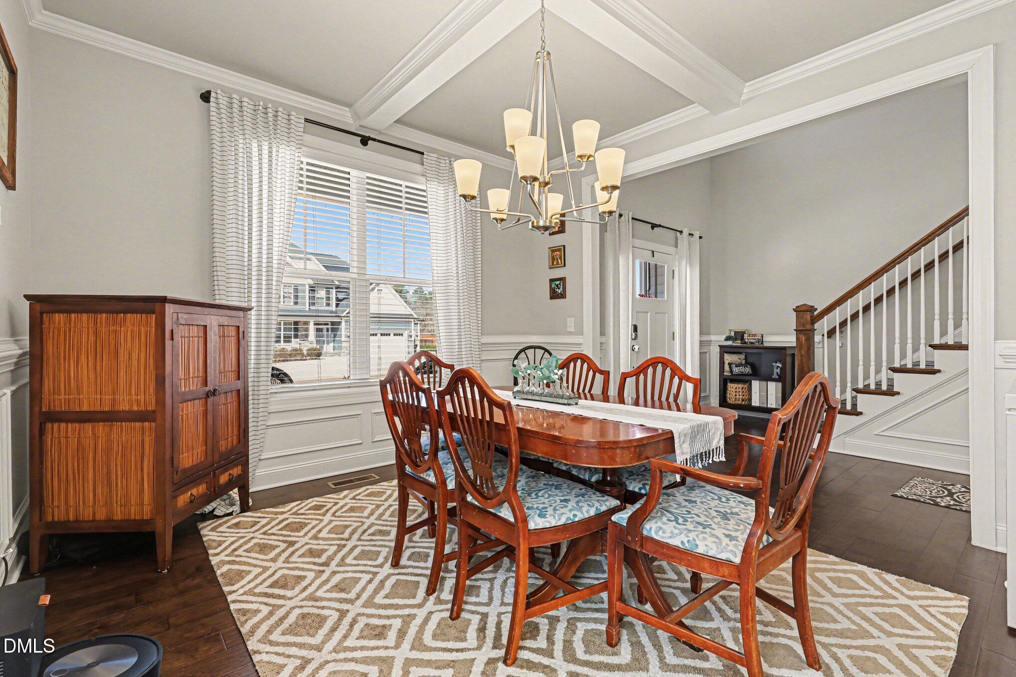 274 Colson Ridge Drive Clayton, NC 27520 - Photo 17 of 48 a dining room with furniture a chandelier and wooden floor