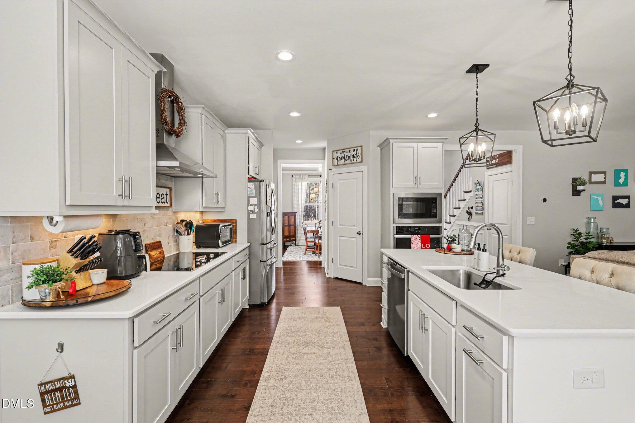 274 Colson Ridge Drive Clayton, NC 27520 - Photo 19 of 48 a kitchen with stainless steel appliances lots of counter space and a sink