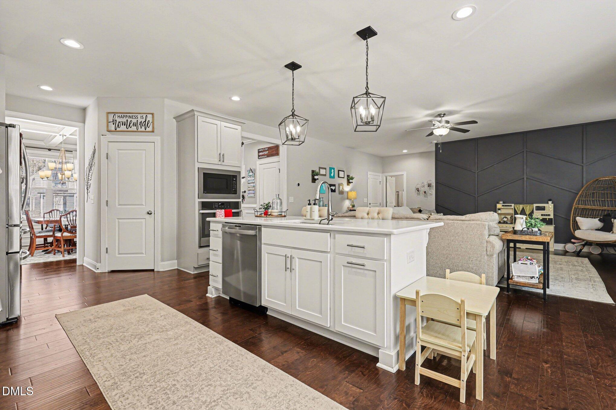 274 Colson Ridge Drive Clayton, NC 27520 - Photo 20 of 48 an open kitchen with white cabinets and stainless steel appliances