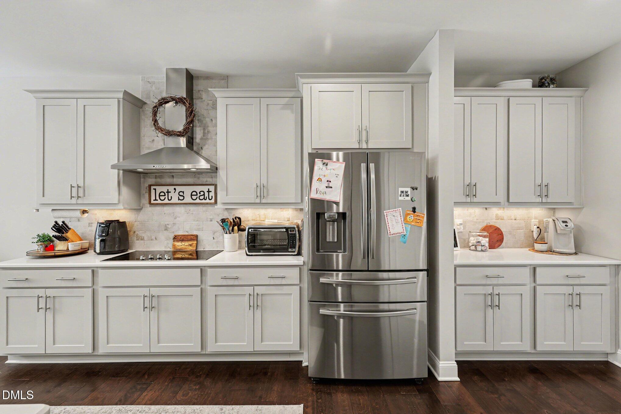 274 Colson Ridge Drive Clayton, NC 27520 - Photo 24 of 48 a kitchen with white cabinets and stainless steel appliances