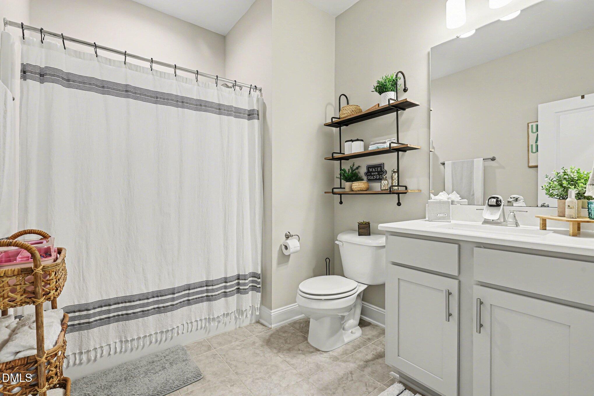 274 Colson Ridge Drive Clayton, NC 27520 - Photo 26 of 48 a bathroom with a sink a toilet and shower