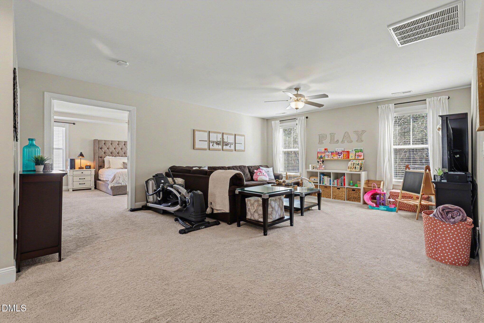 274 Colson Ridge Drive Clayton, NC 27520 - Photo 34 of 48 a living room with furniture and a gym machine