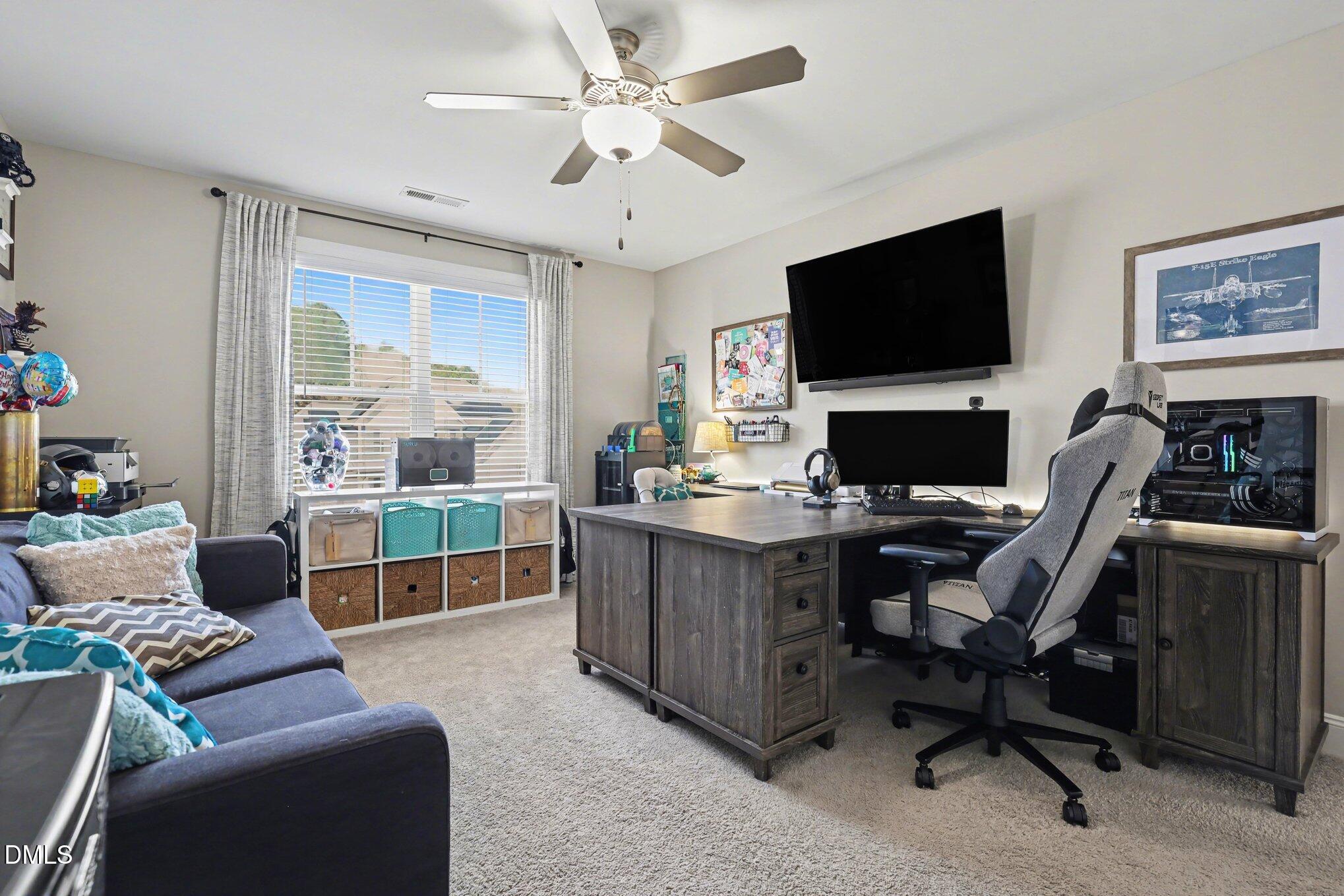 274 Colson Ridge Drive Clayton, NC 27520 - Photo 36 of 48 a view of a livingroom with workspace and a couch