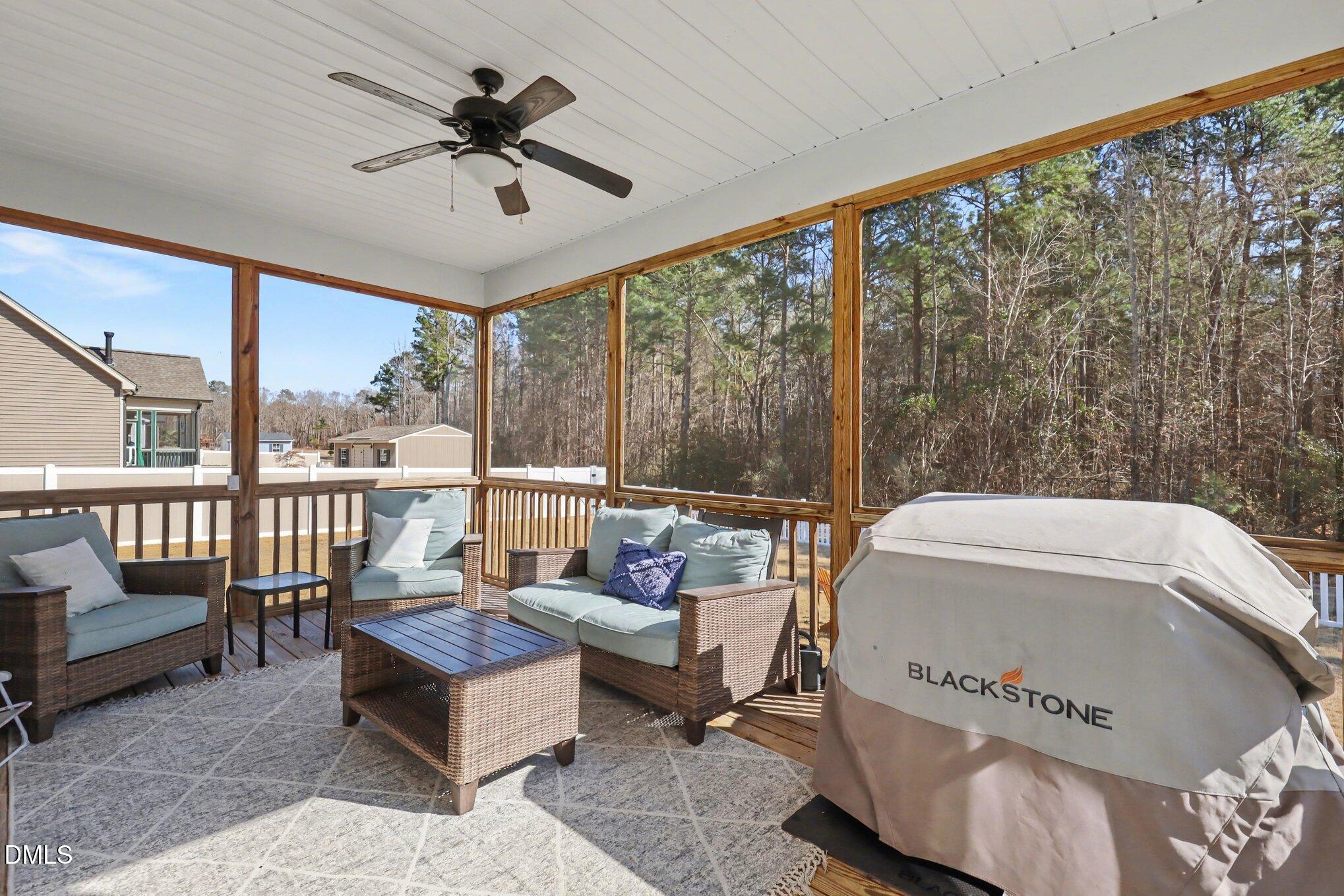 274 Colson Ridge Drive Clayton, NC 27520 - Photo 41 of 48 a living room with furniture and a floor to ceiling window