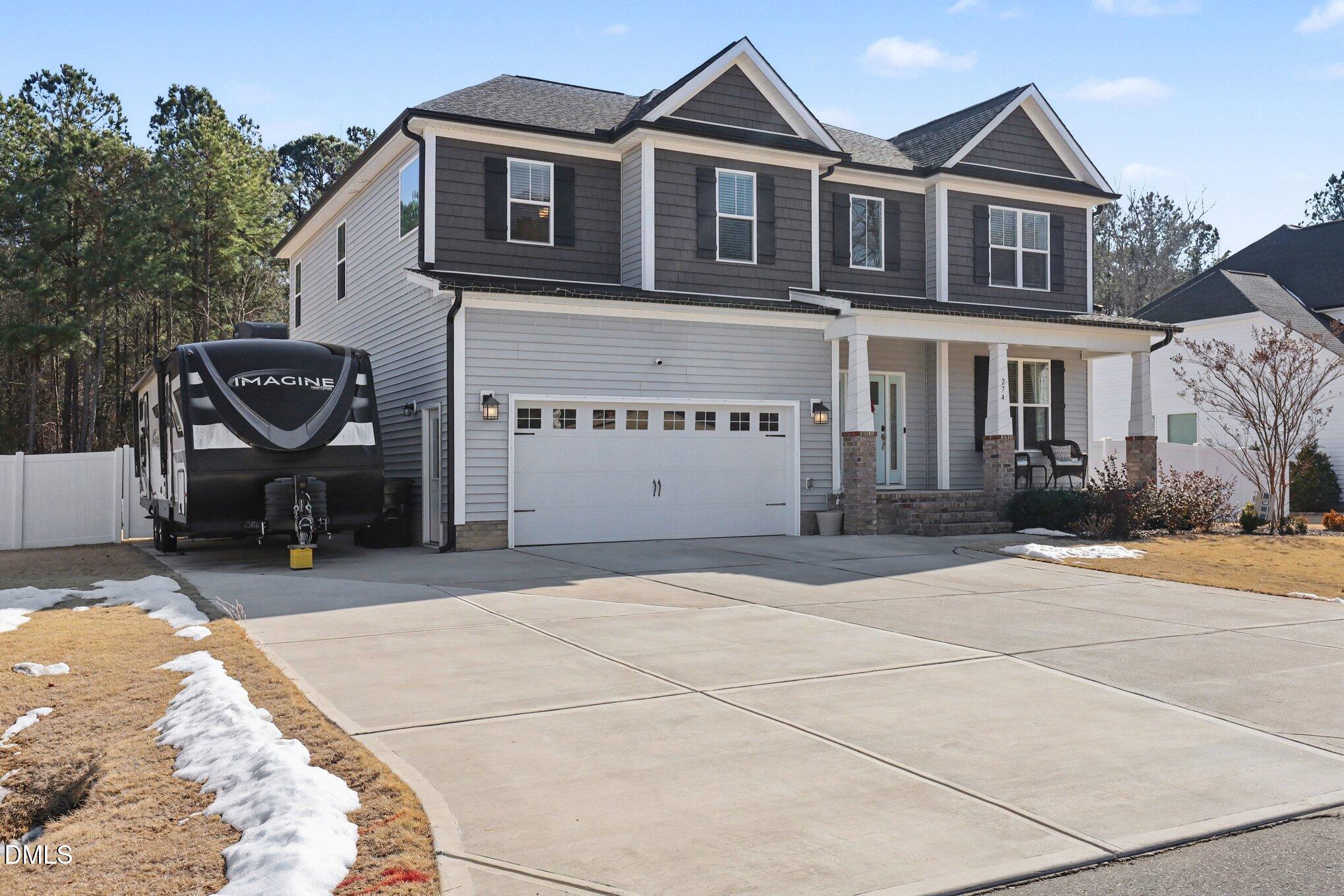274 Colson Ridge Drive Clayton, NC 27520 - Photo 6 of 48 a front view of a house with a yard and garage