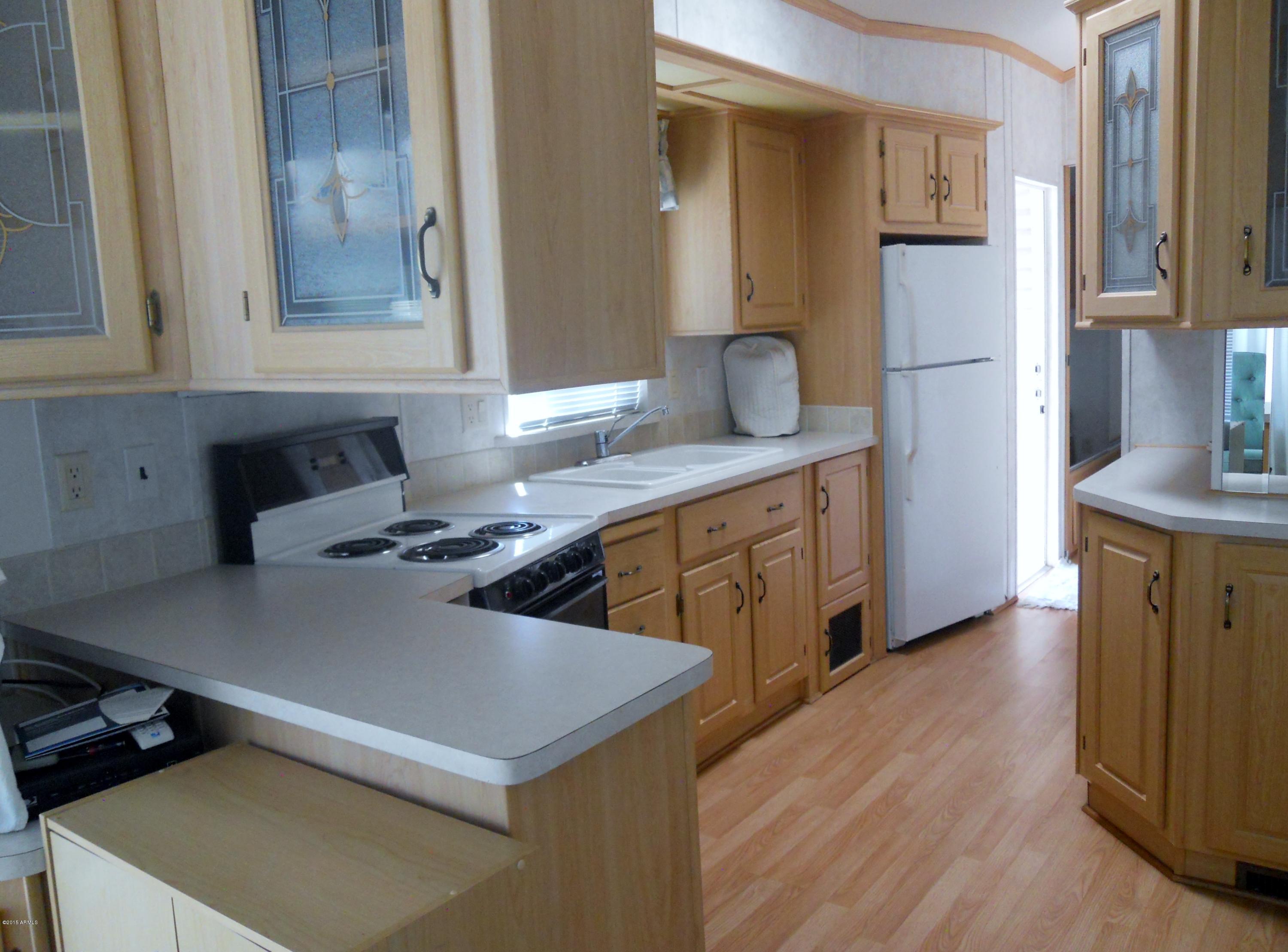 17200 West Bell Road, Unit 798 Surprise, AZ 85374 - Photo 3 of 4 a kitchen with stainless steel appliances a stove a sink and a refrigerator