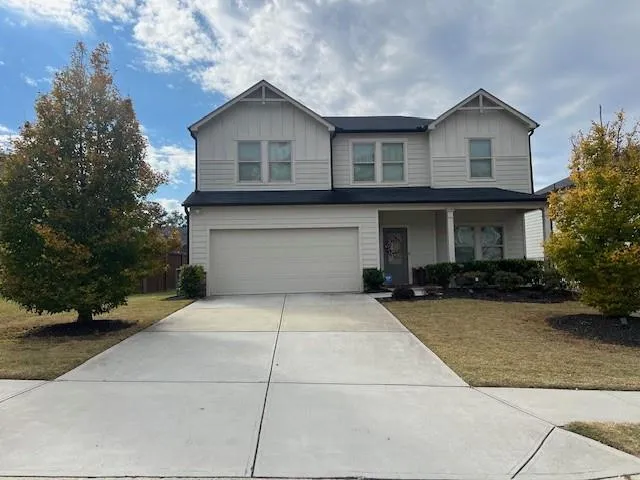 a front view of a house with a yard and garage