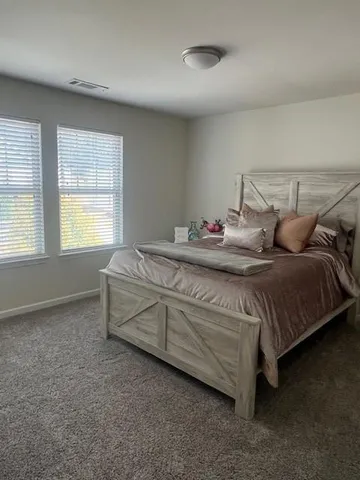 a bedroom with bed and window