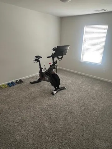 a room with gym equipment and a window