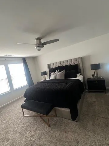 a bedroom with a bed and window