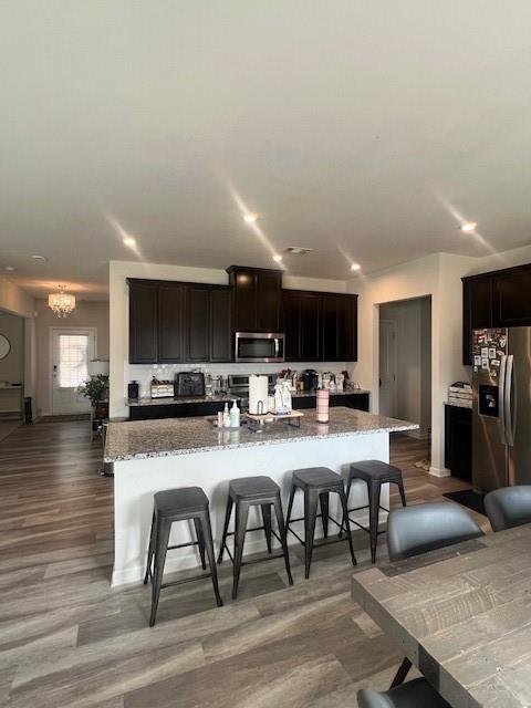 1905 Azure Grove Court Marietta, GA 30008 - Photo 5 of 29 a kitchen with stainless steel appliances a dining table chairs and a wooden floor