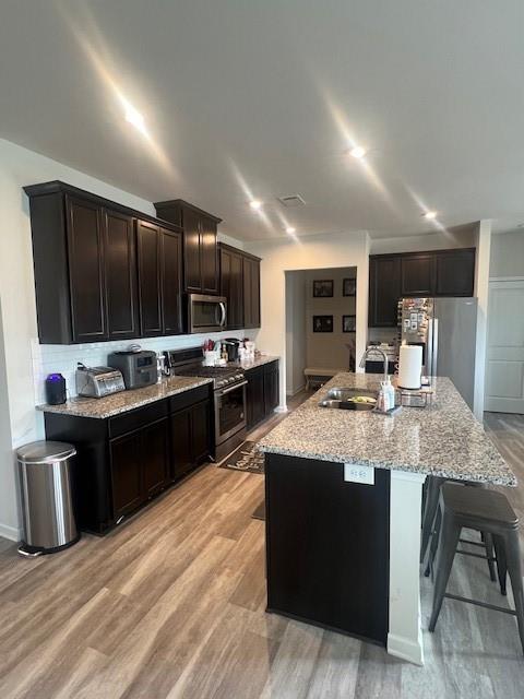 1905 Azure Grove Court Marietta, GA 30008 - Photo 6 of 29 a open kitchen with kitchen island granite countertop stainless steel appliances and wooden cabinets