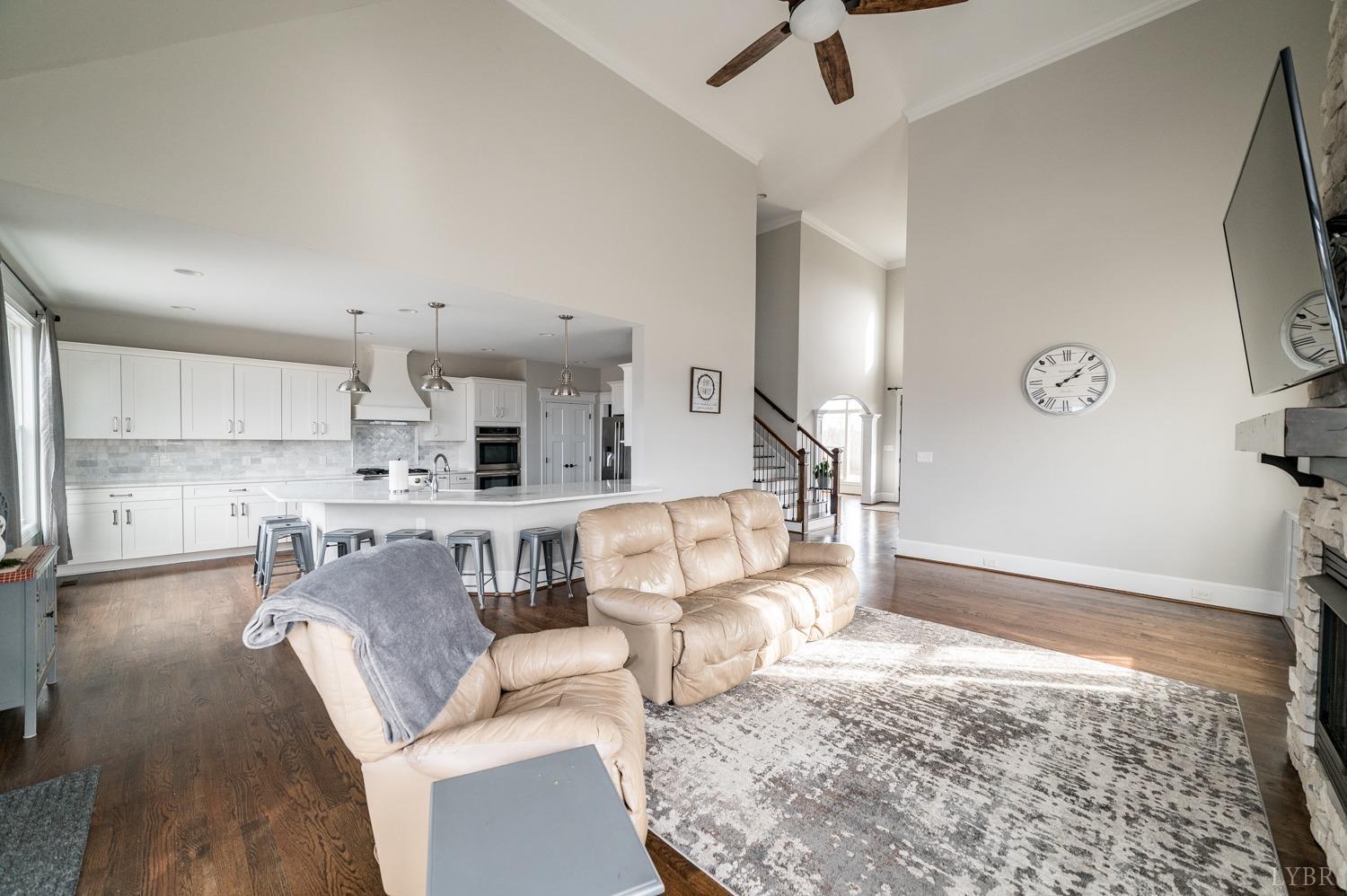 967 Lynbrook Road Rustburg, VA 24588 - Photo 37 of 99 a living room with kitchen island granite countertop furniture and a fireplace