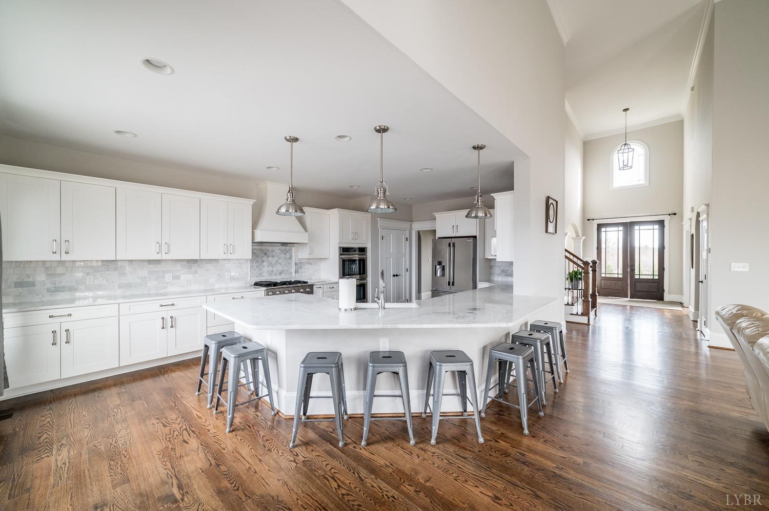 967 Lynbrook Road Rustburg, VA 24588 - Photo 40 of 99 a kitchen with stainless steel appliances granite countertop a stove top oven a sink a dining table and chairs with wooden floor