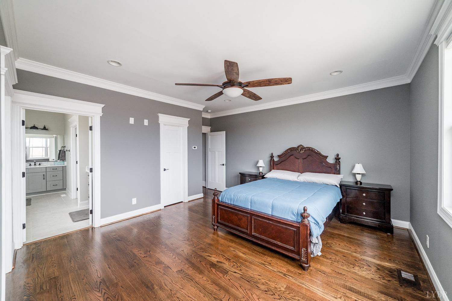 967 Lynbrook Road Rustburg, VA 24588 - Photo 52 of 99 a bedroom with a bed and a chandelier