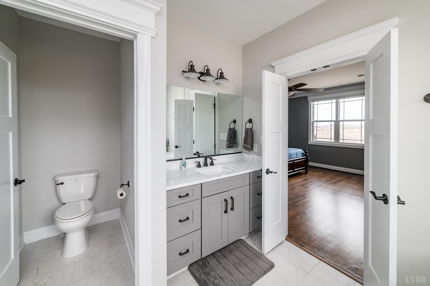 967 Lynbrook Road Rustburg, VA 24588 - Photo 57 of 99 a spacious bathroom with a toilet sink double vanity and mirror