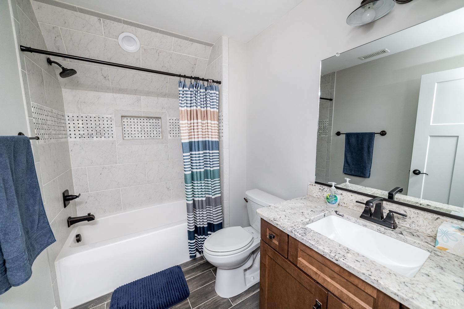 967 Lynbrook Road Rustburg, VA 24588 - Photo 70 of 99 a bathroom with a granite countertop sink toilet and shower
