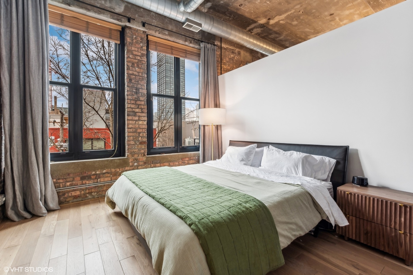 215 North Aberdeen Street, Unit 405A Chicago, IL 60607 - Photo 12 of 20 a bed sitting in a bedroom next to a window