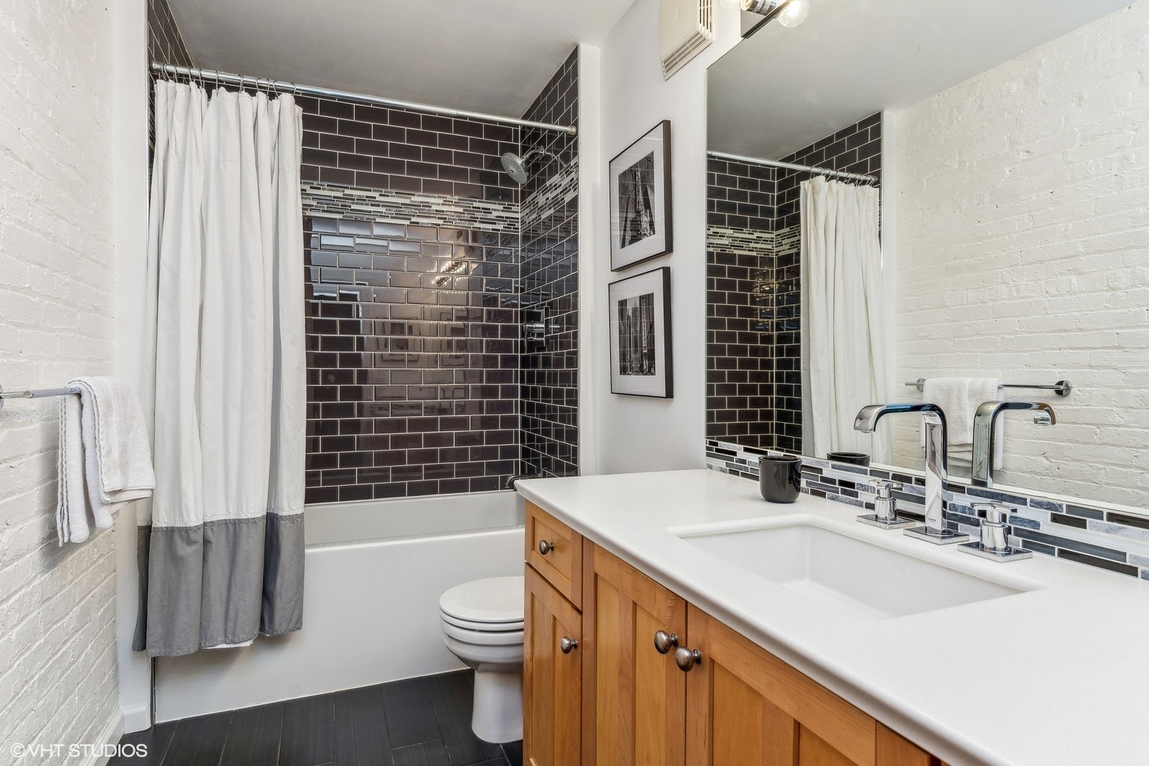215 North Aberdeen Street, Unit 405A Chicago, IL 60607 - Photo 14 of 20 a bathroom with a sink toilet a shower and a mirror