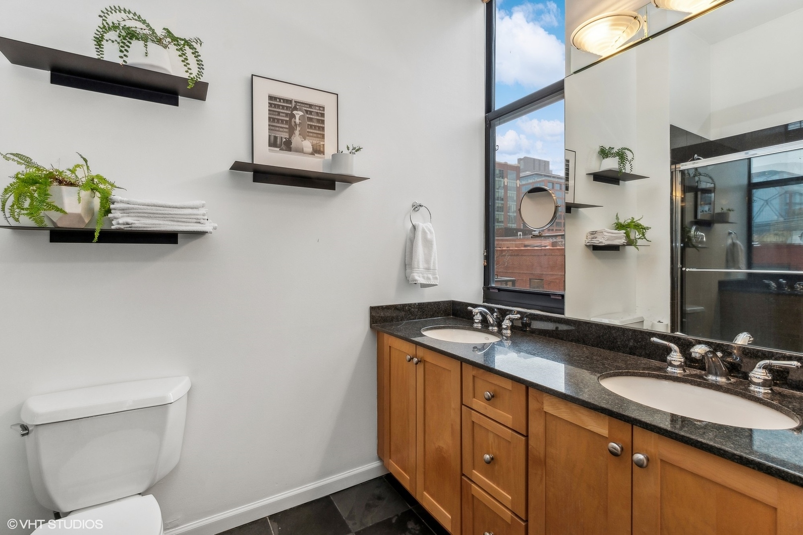 215 North Aberdeen Street, Unit 405A Chicago, IL 60607 - Photo 15 of 20 a bathroom with a granite countertop sink a toilet and a mirror