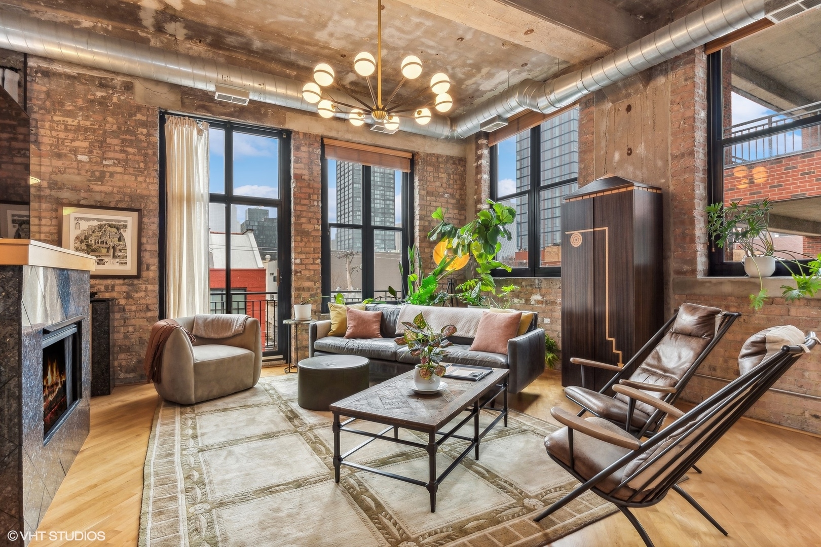 215 North Aberdeen Street, Unit 405A Chicago, IL 60607 - Photo 2 of 20 a living room with fireplace furniture and a chandelier