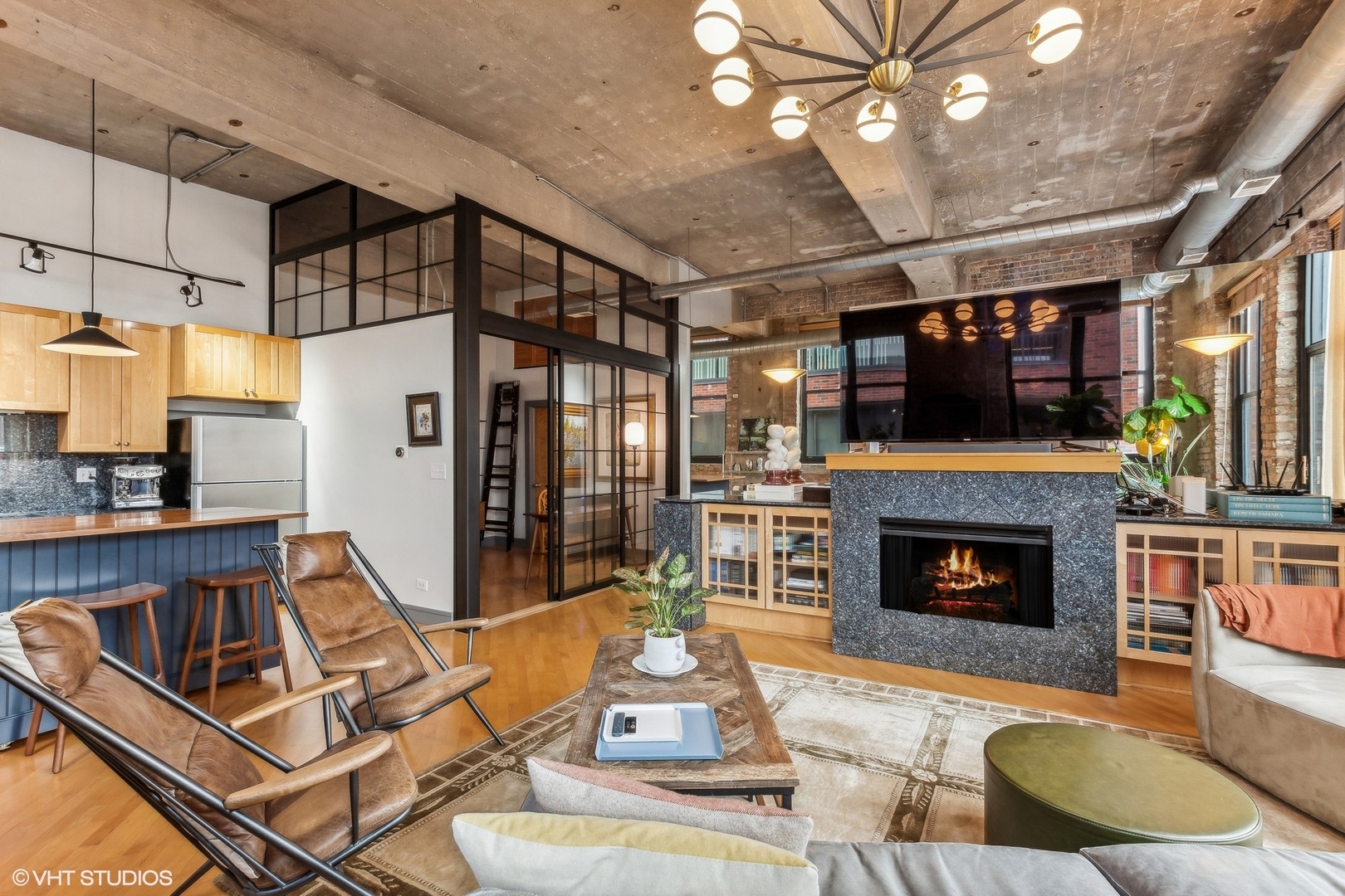 215 North Aberdeen Street, Unit 405A Chicago, IL 60607 - Photo 5 of 20 a living room with furniture a flat screen tv and a fireplace