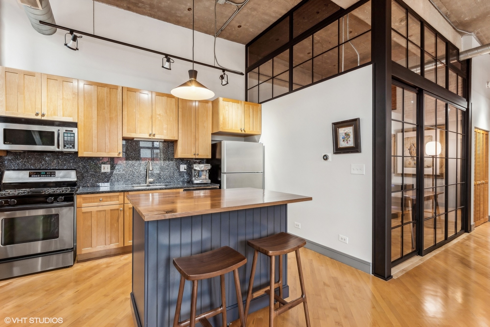 215 North Aberdeen Street, Unit 405A Chicago, IL 60607 - Photo 7 of 20 a kitchen with stainless steel appliances granite countertop a stove and a refrigerator