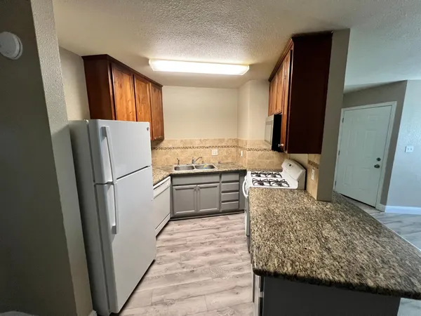 a kitchen with a refrigerator sink and stove