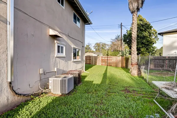 a view of a house with backyard and sitting area