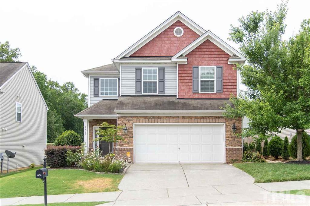 1308 Lombar Street Raleigh, NC 27610 - Photo 1 of 26 a front view of a house with garden