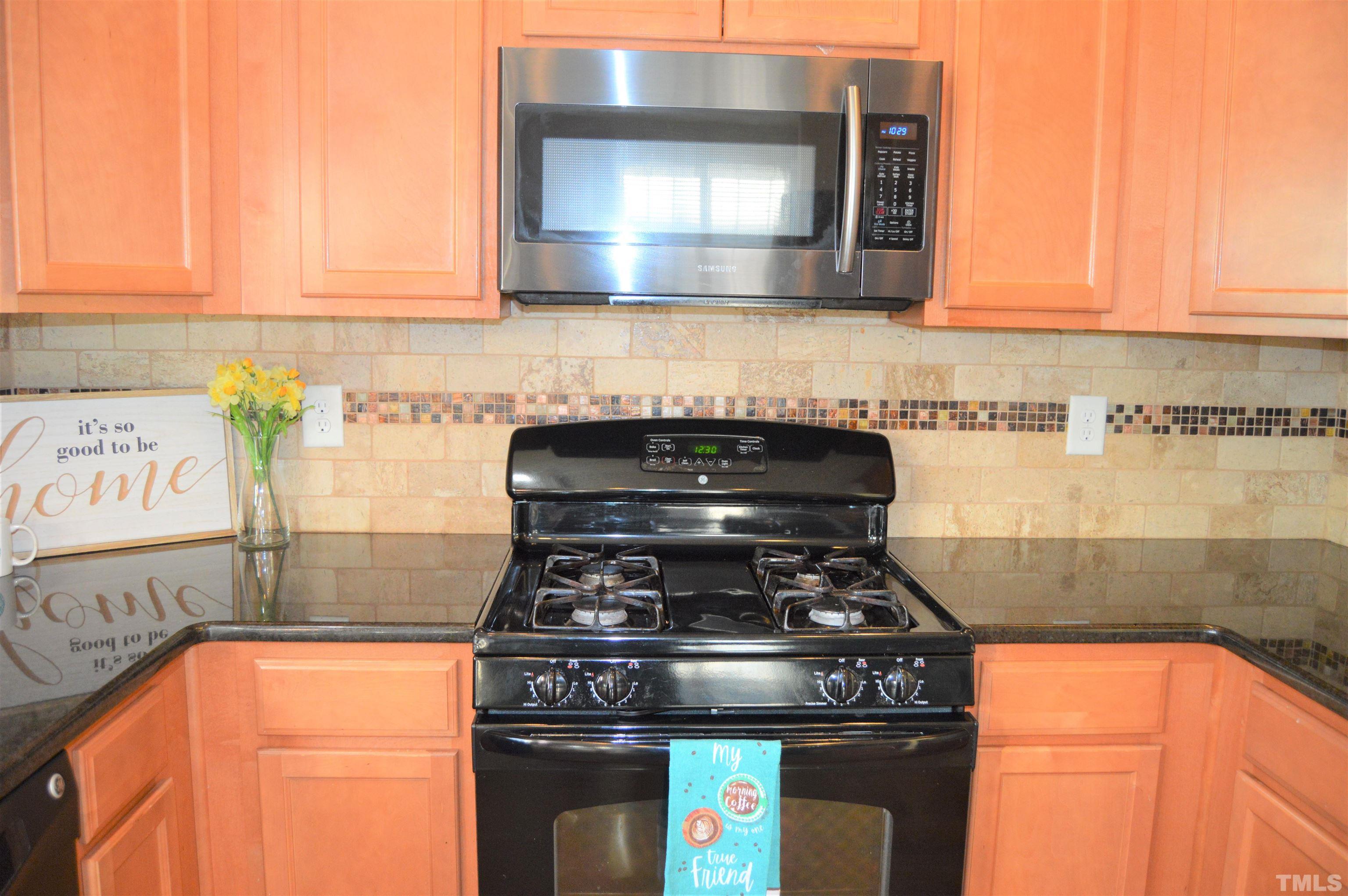 1308 Lombar Street Raleigh, NC 27610 - Photo 11 of 26 a stove top oven sitting inside of a kitchen