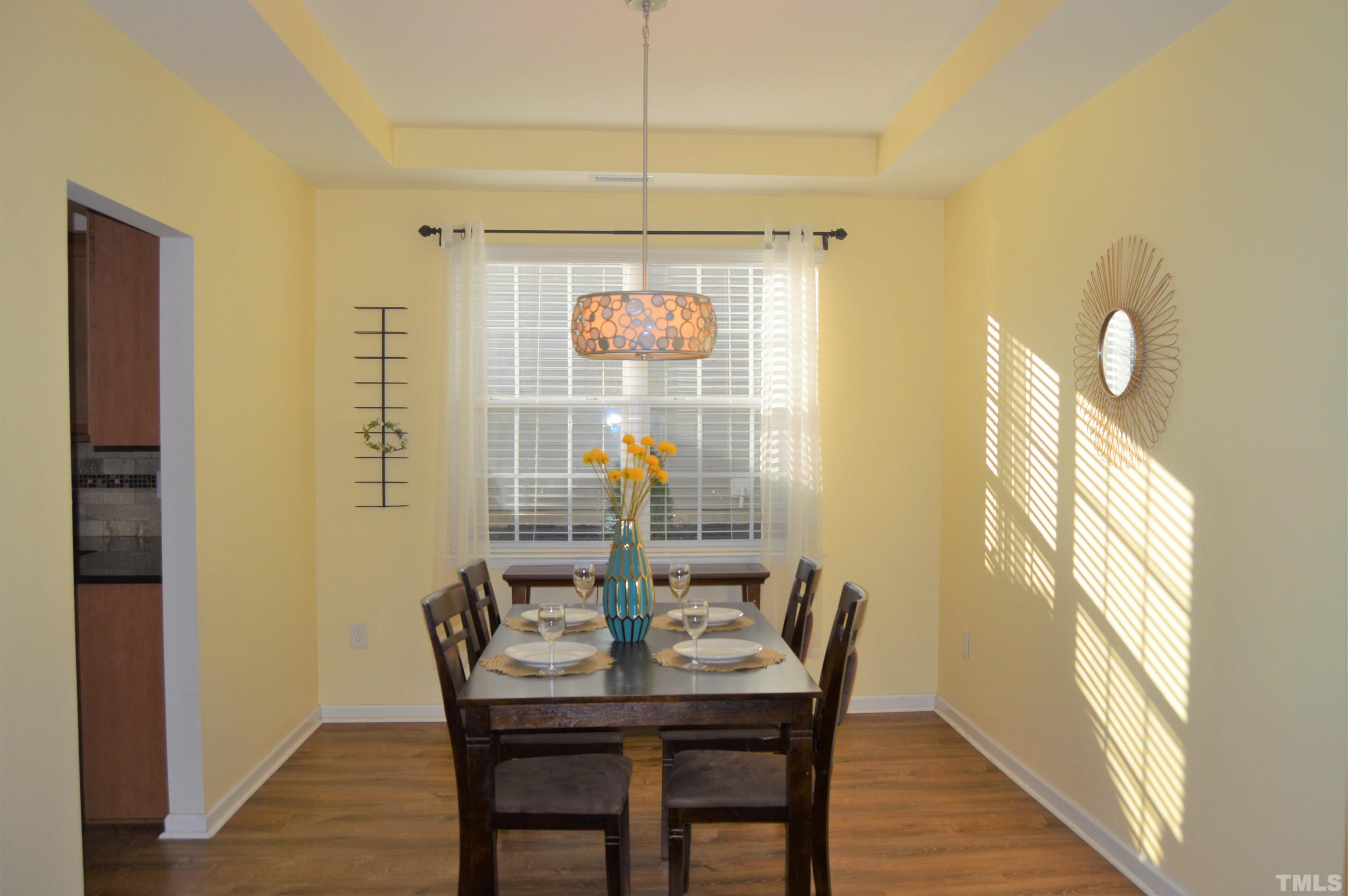 1308 Lombar Street Raleigh, NC 27610 - Photo 12 of 26 a view of a dining room with furniture and wooden floor