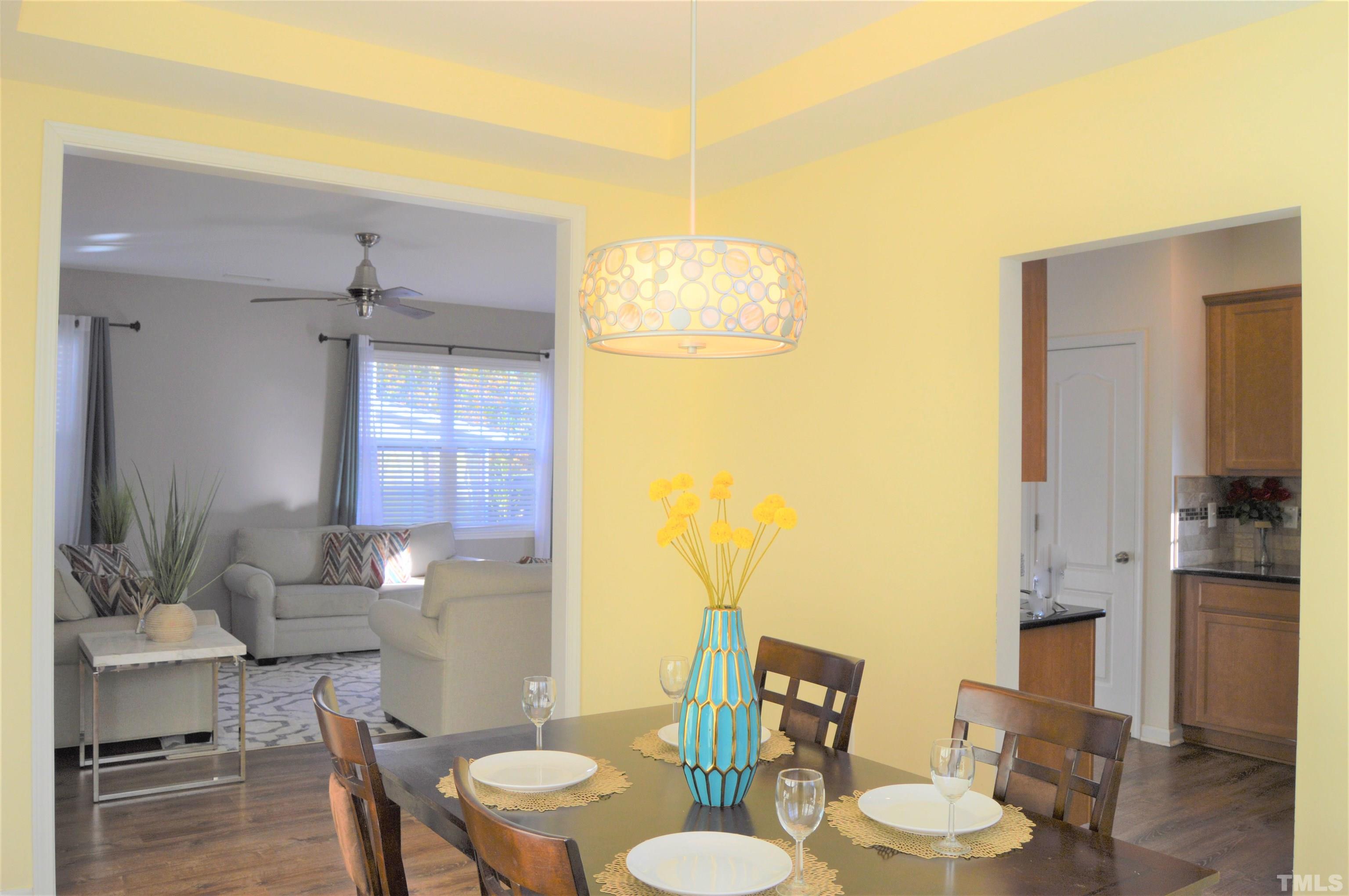 1308 Lombar Street Raleigh, NC 27610 - Photo 13 of 26 a dining room with furniture and wooden floor
