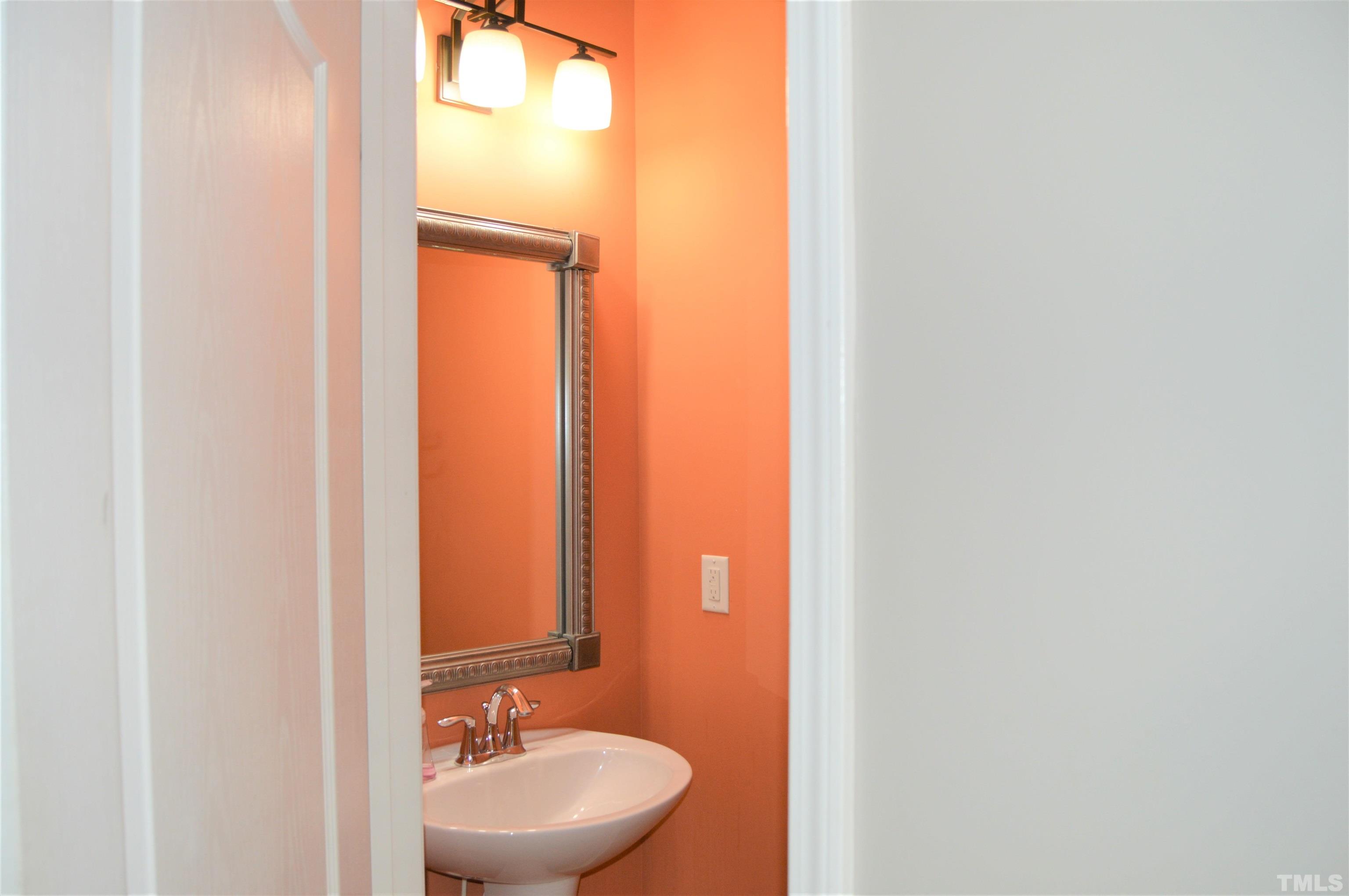 1308 Lombar Street Raleigh, NC 27610 - Photo 14 of 26 a bathroom with a sink and a mirror