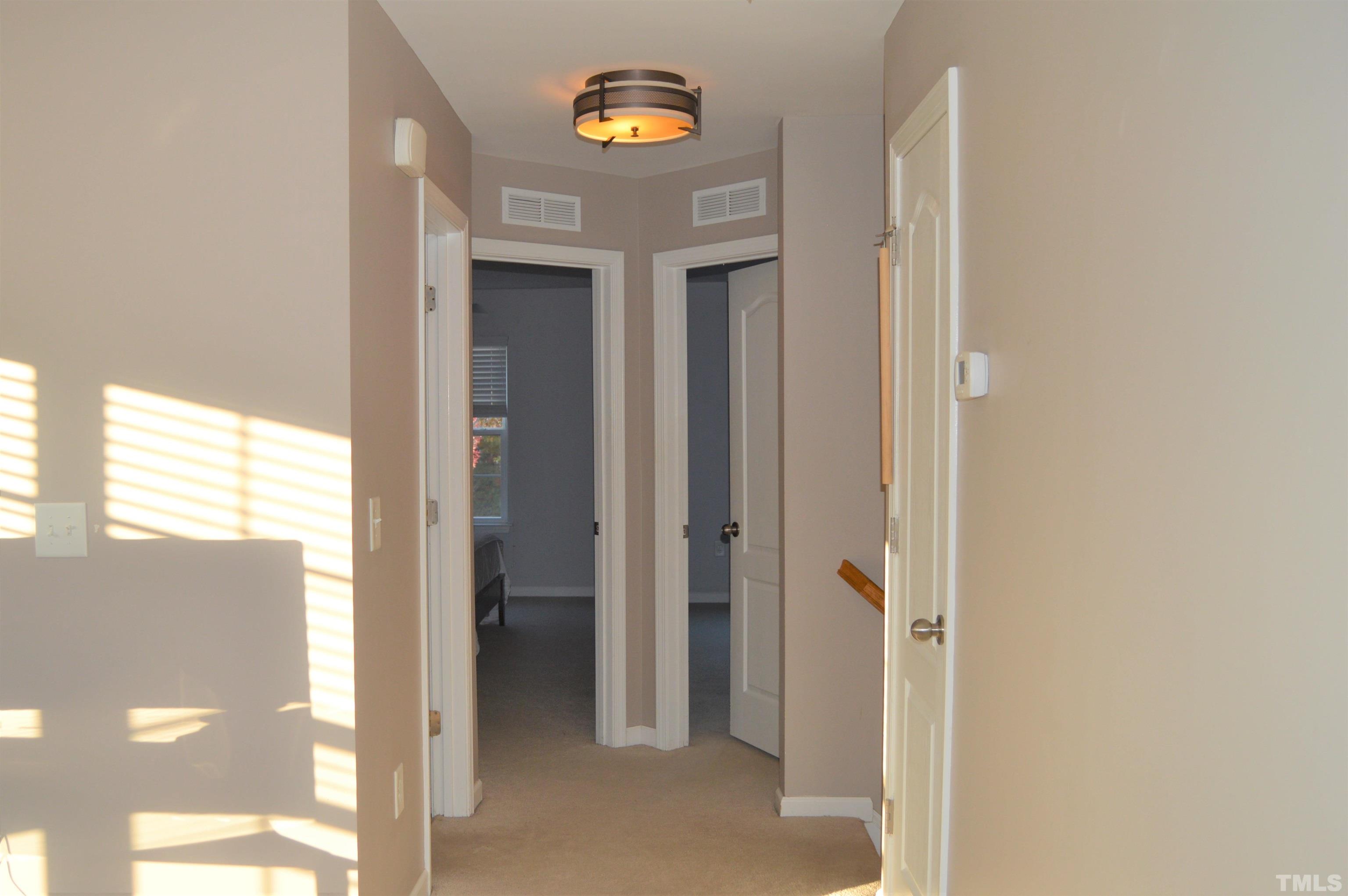 1308 Lombar Street Raleigh, NC 27610 - Photo 16 of 26 a view of a hallway with wooden floor and a room