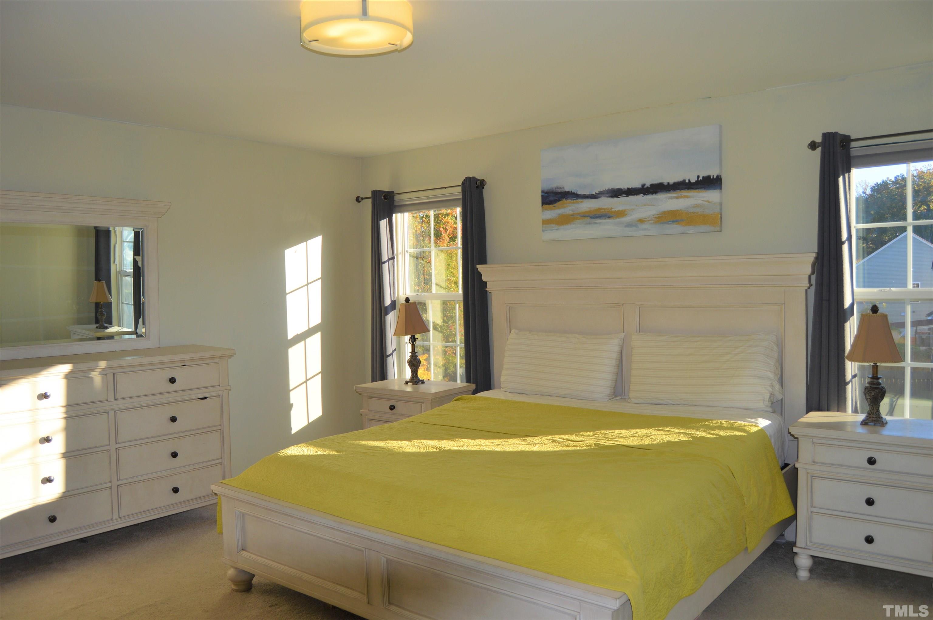 1308 Lombar Street Raleigh, NC 27610 - Photo 17 of 26 a bedroom with a bed and a dresser