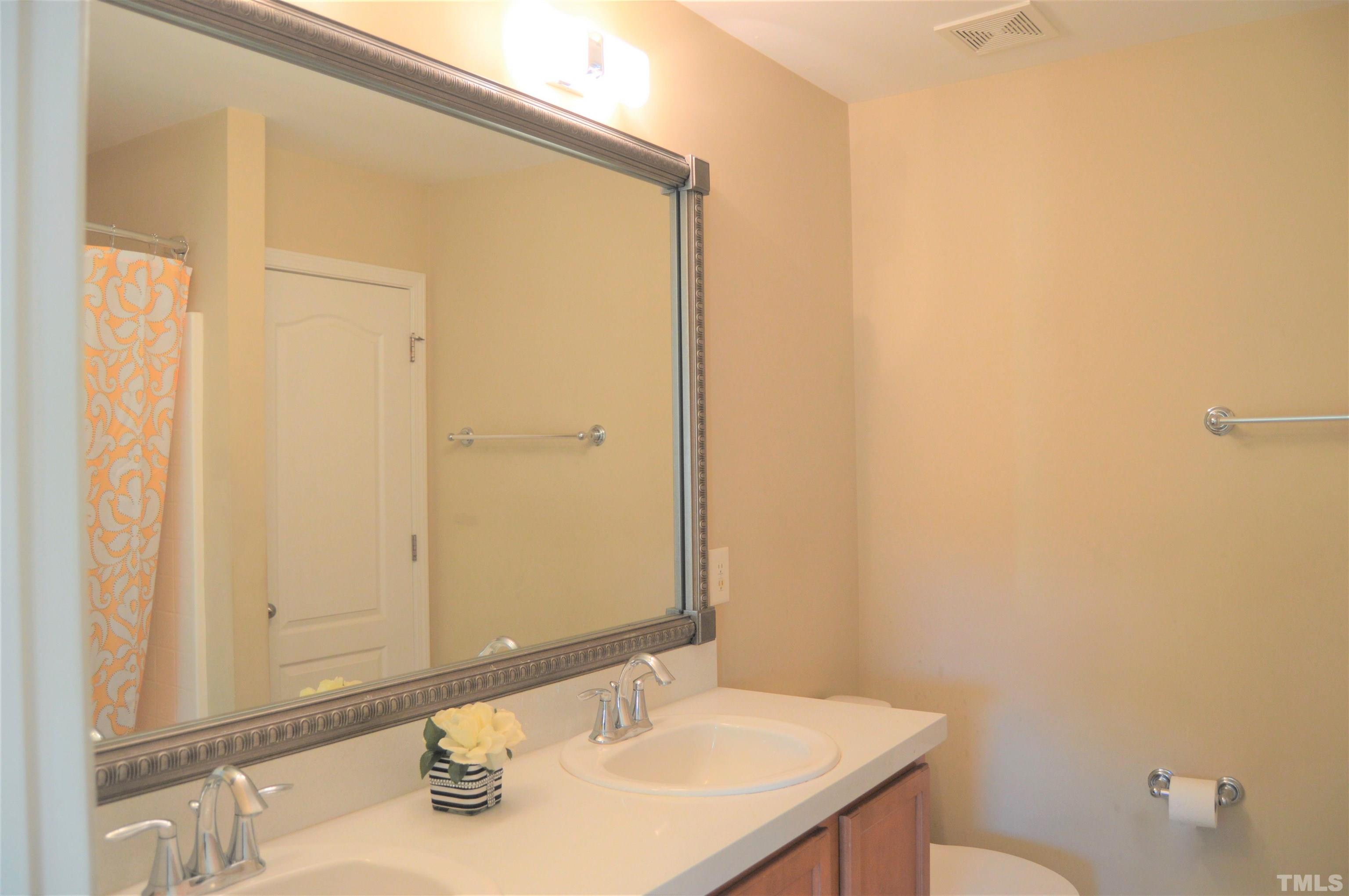 1308 Lombar Street Raleigh, NC 27610 - Photo 19 of 26 a bathroom with a sink and a mirror