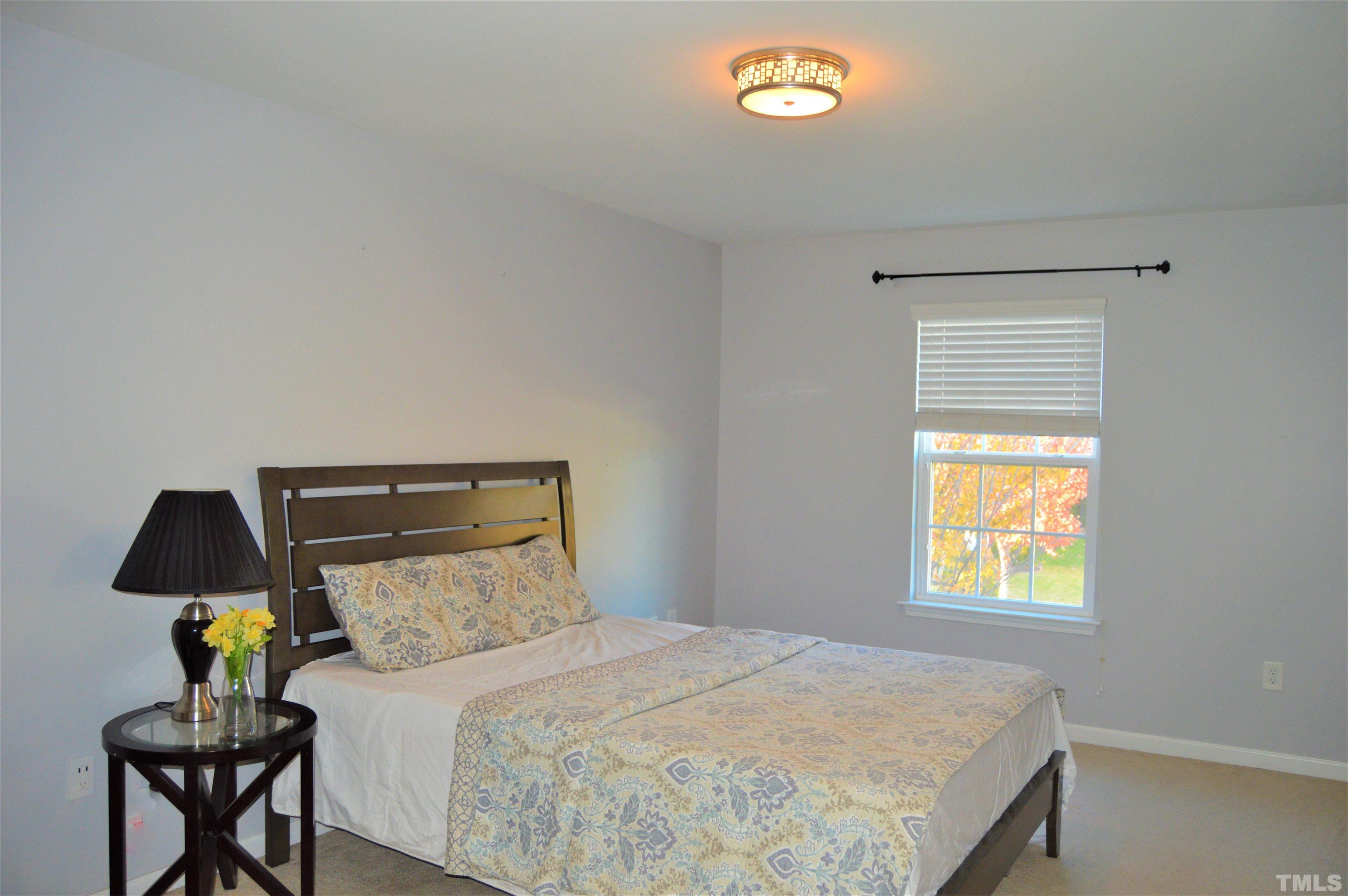 1308 Lombar Street Raleigh, NC 27610 - Photo 20 of 26 a bedroom with a bed and a window