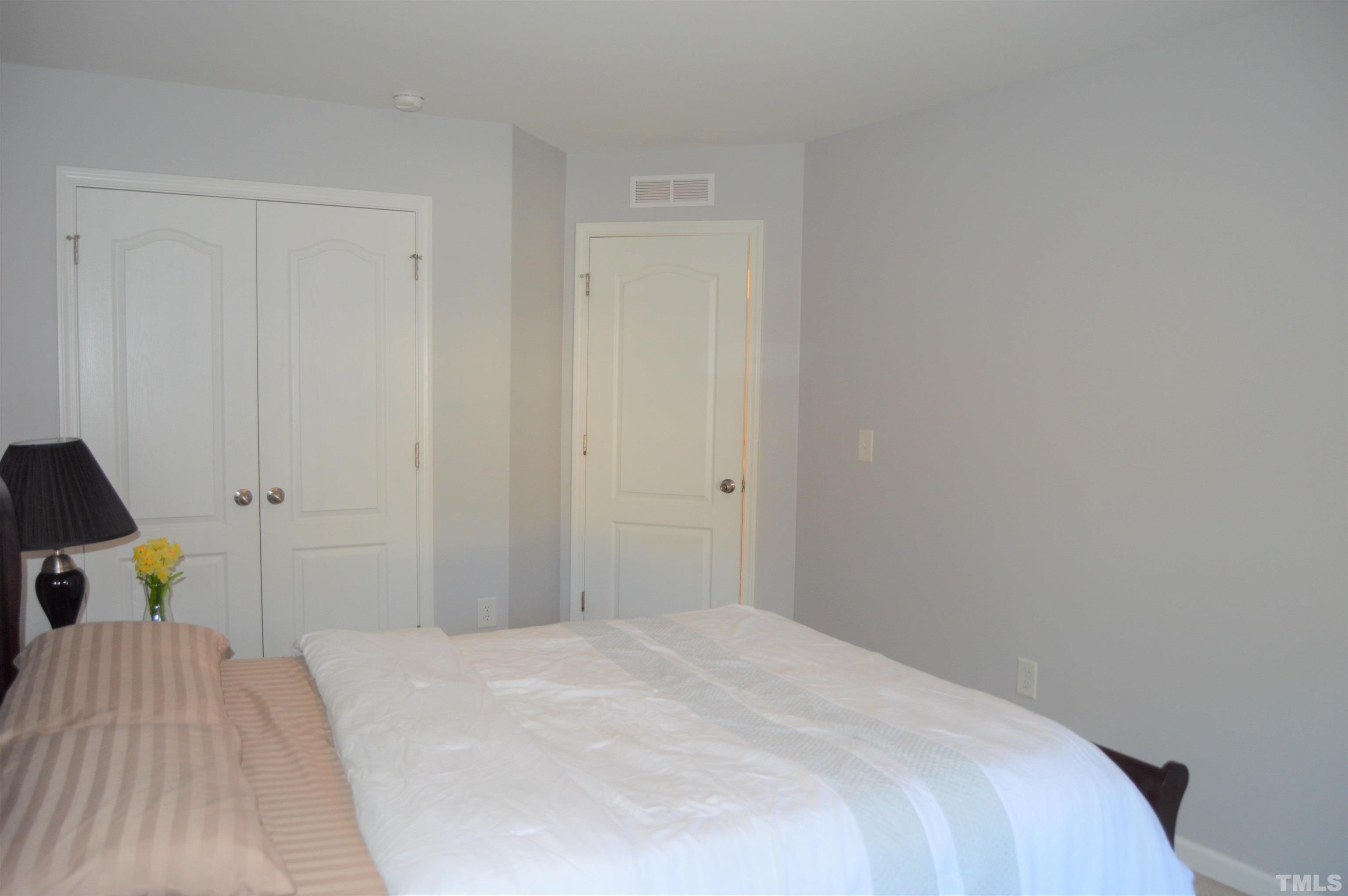 1308 Lombar Street Raleigh, NC 27610 - Photo 21 of 26 a bedroom with a bed and wooden floor