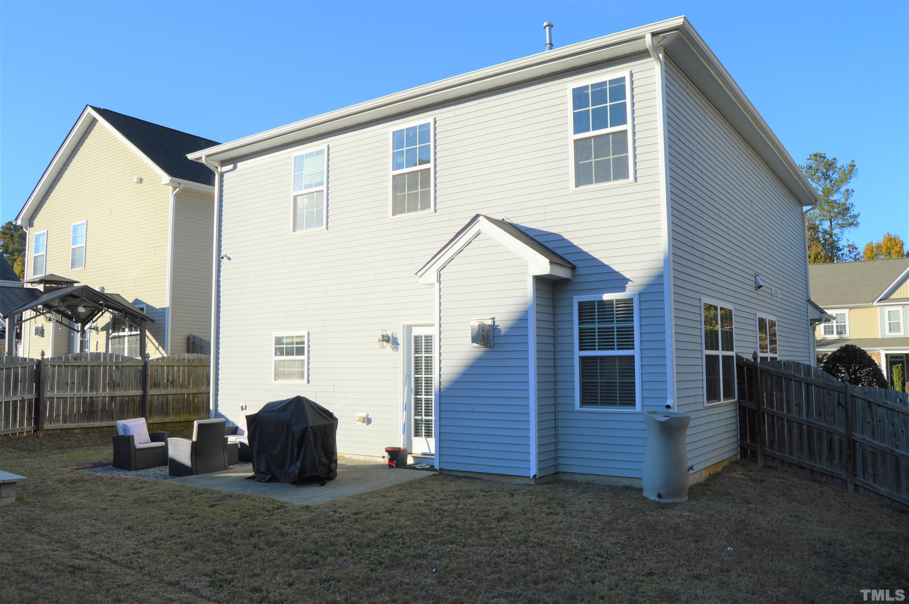 1308 Lombar Street Raleigh, NC 27610 - Photo 24 of 26 a view of backyard with barbeque grill and wooden fence