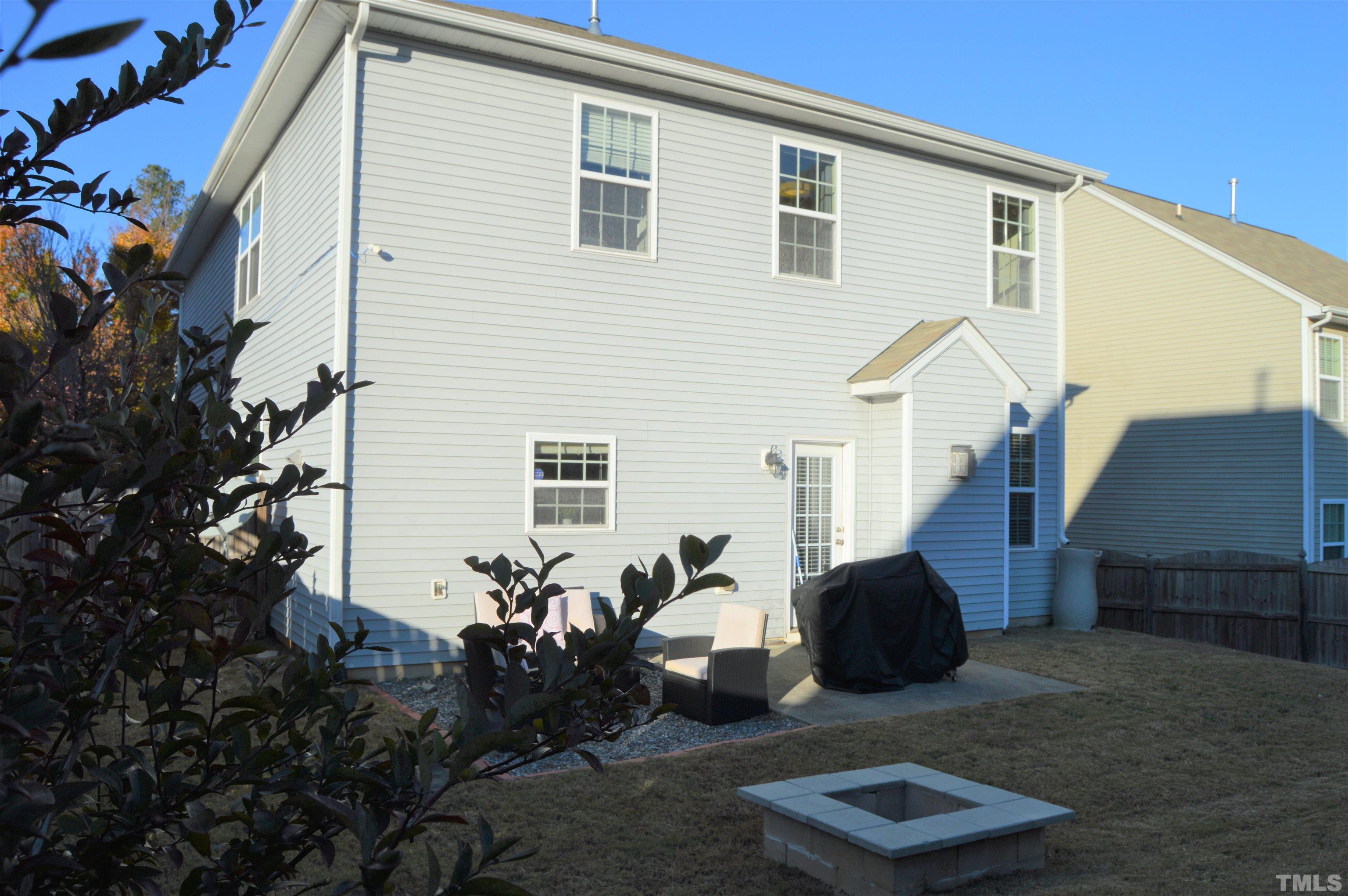 1308 Lombar Street Raleigh, NC 27610 - Photo 26 of 26 a backyard of a house with barbeque oven and outdoor seating