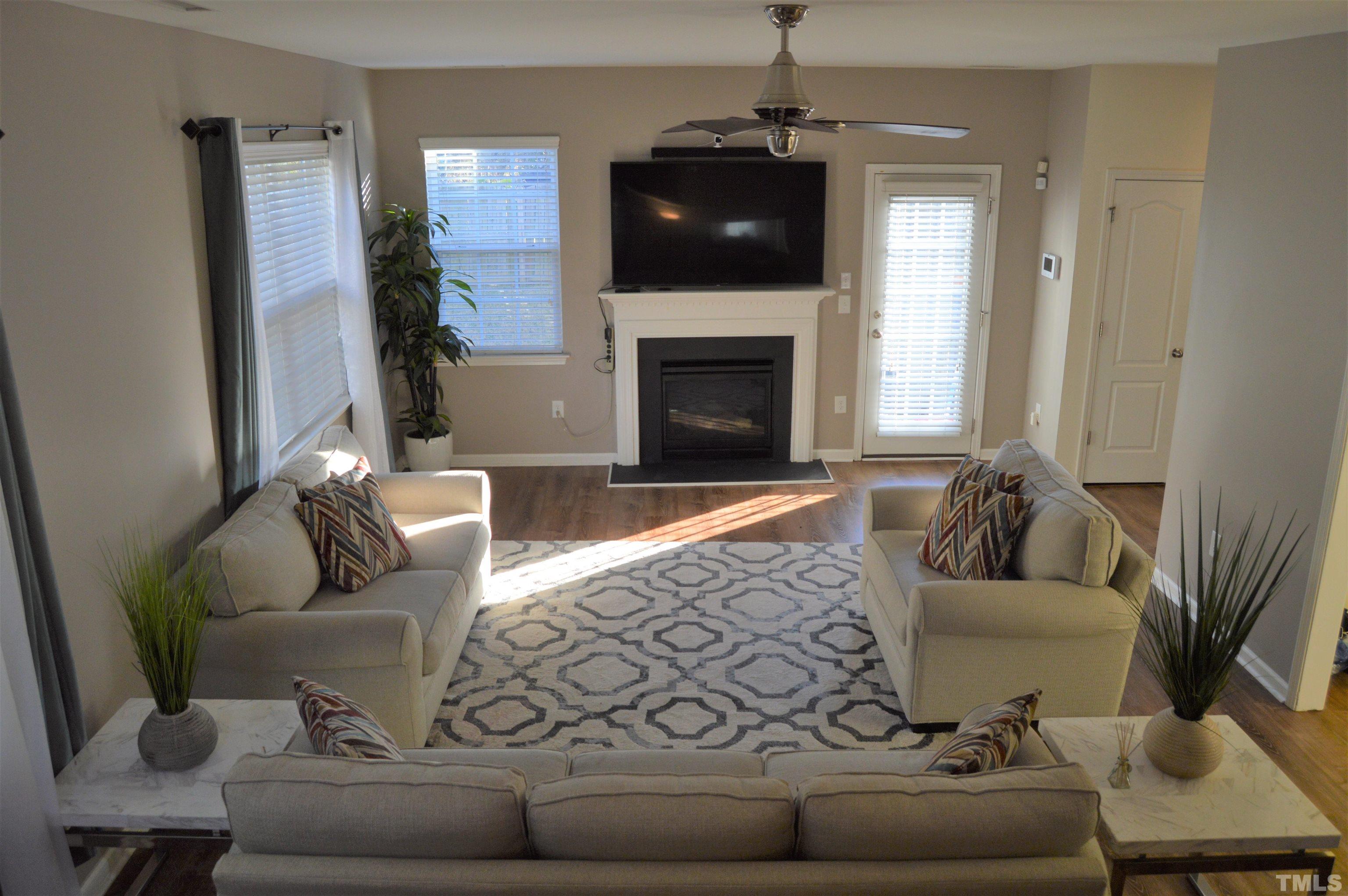 1308 Lombar Street Raleigh, NC 27610 - Photo 4 of 26 a living room with furniture and a fireplace