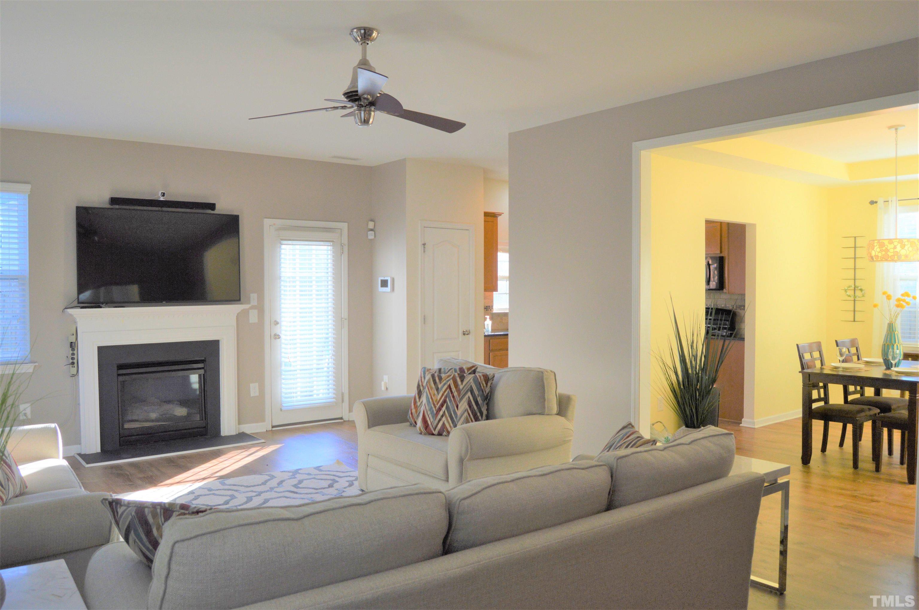 1308 Lombar Street Raleigh, NC 27610 - Photo 7 of 26 a living room with furniture a fireplace and a flat screen tv