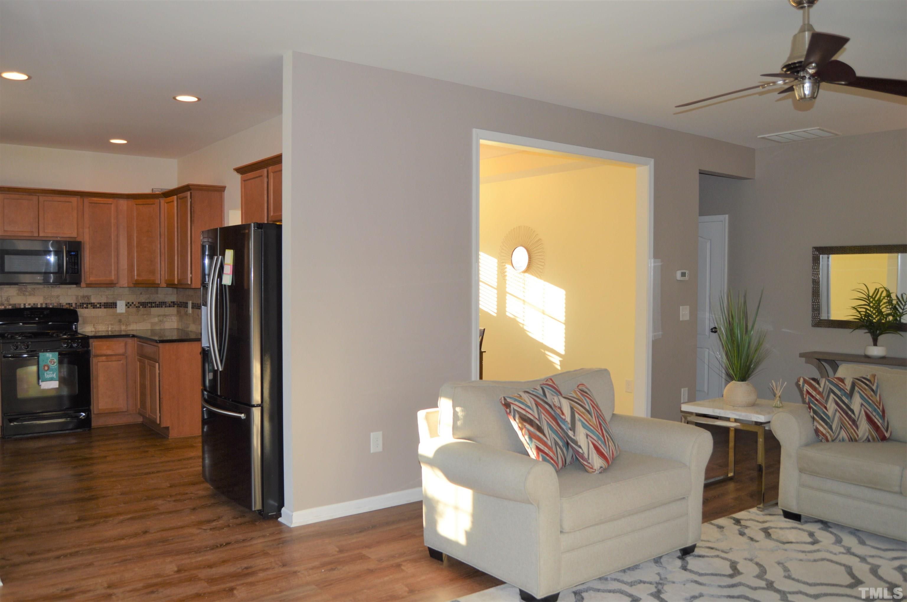 1308 Lombar Street Raleigh, NC 27610 - Photo 8 of 26 a living room with furniture and a flat screen tv